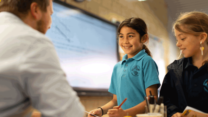 Two students and a teacher interacting